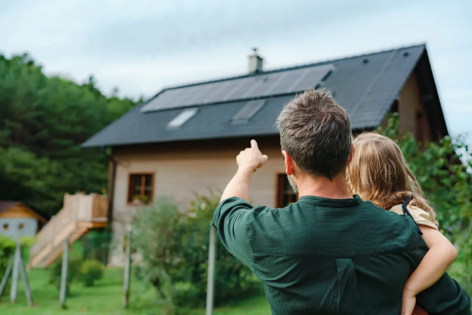 A family outside their solar-powered home